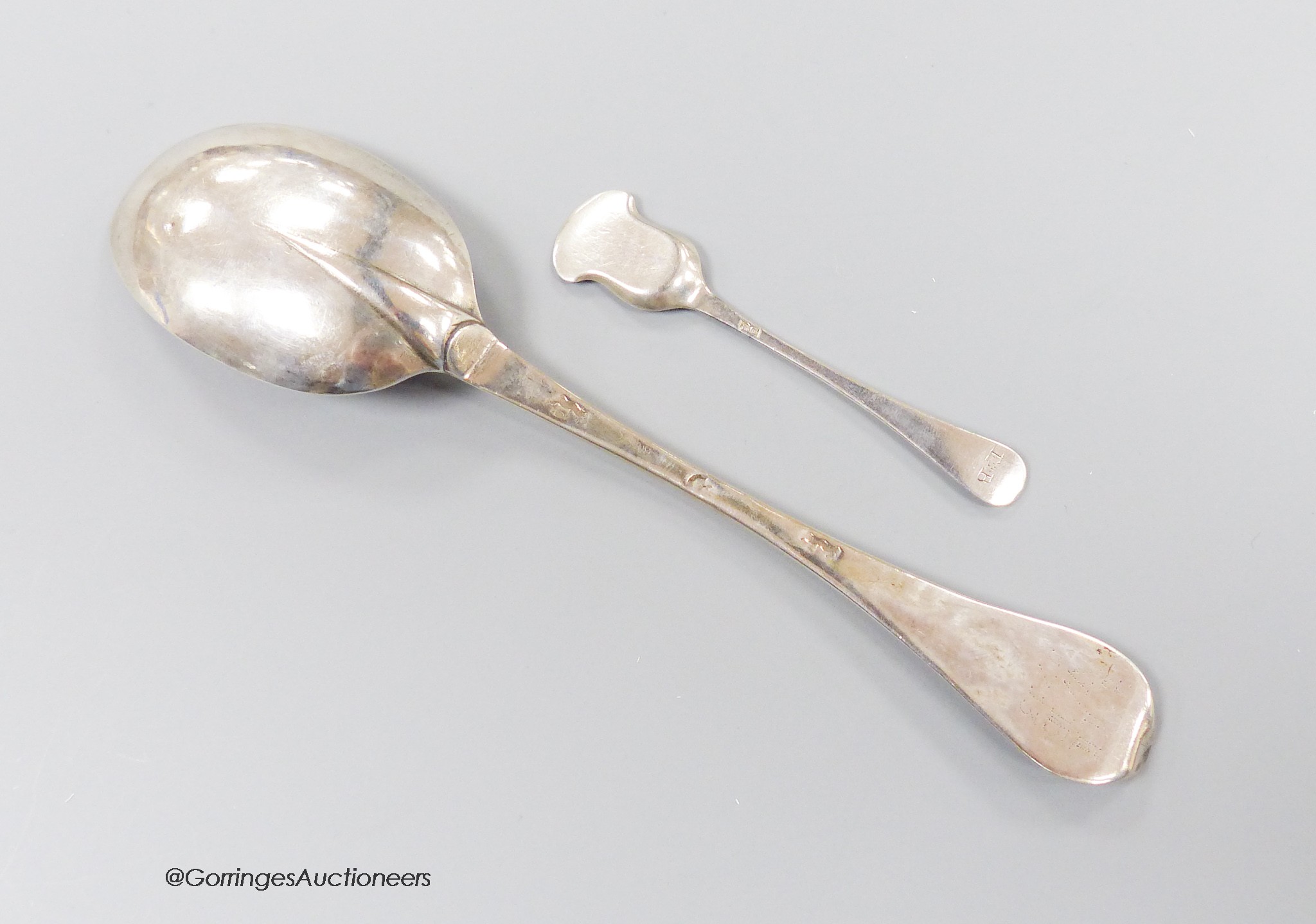 An early 18th century silver dog nose spoon, with engraved prick dot initials with date 1713, indistinct marks, 19.7cm, together with an 18th century Bristol? salt shovel, possibly Ralph Goode, c.1735, gross 46 grams.